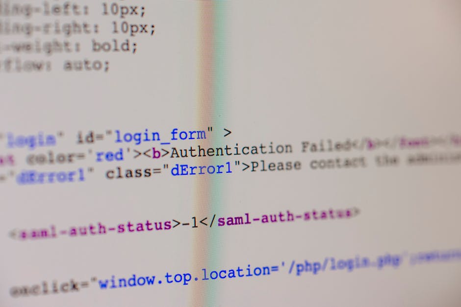 The image depicts a close-up view of a computer screen displaying lines of HTML and CSS code with various tags, attributes, and color-coded syntax highlighting. The code appears to be part of a login 